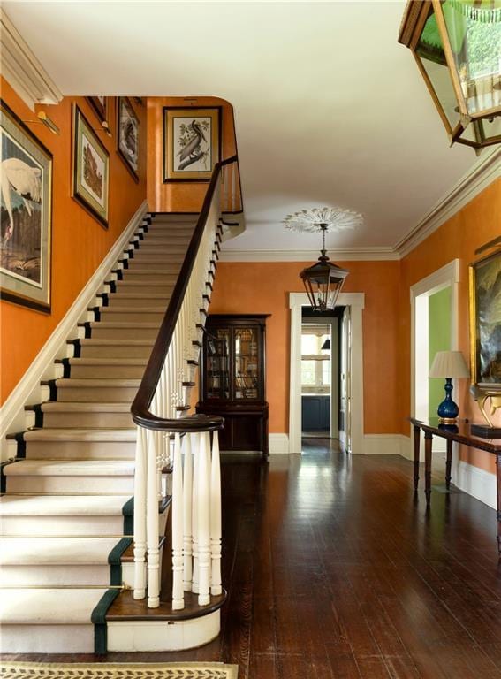 2425 Coliseum St, New Orleans, LA 70130 - stairway featuring baseboards, hardwood / wood-style flooring, and crown molding