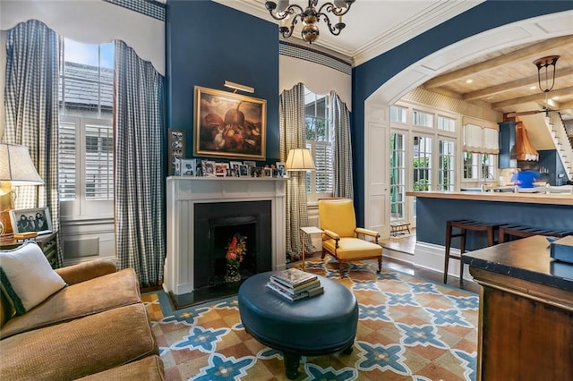 2425 Coliseum St, New Orleans, LA 70130 - sitting room featuring crown molding, beamed ceiling, and a fireplace with raised hearth