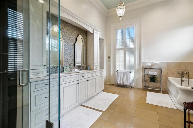 2425 Coliseum St, New Orleans, LA 70130 - bathroom featuring ornamental molding, a soaking tub, double vanity, tile patterned floors, and a stall shower