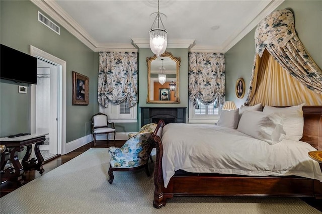 2425 Coliseum St, New Orleans, LA 70130 - bedroom featuring wood finished floors, baseboards, ornamental molding, and visible vents