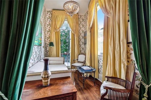 2425 Coliseum St, New Orleans, LA 70130 - sitting room with a notable chandelier, wallpapered walls, and wood finished floors