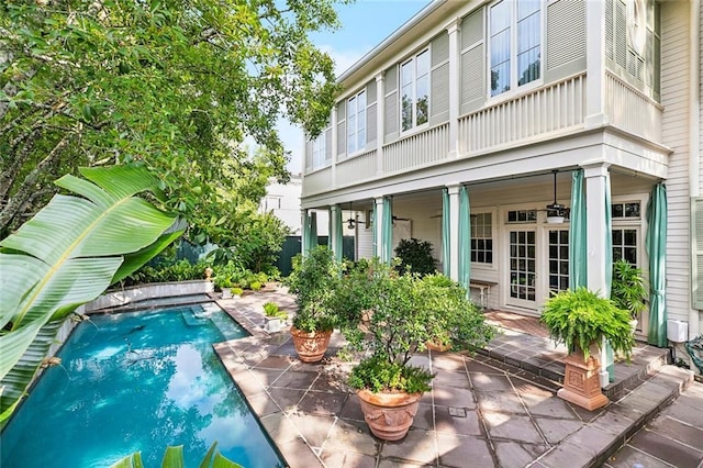 2425 Coliseum St, New Orleans, LA 70130 - rear view of house featuring a patio, an outdoor pool, and french doors