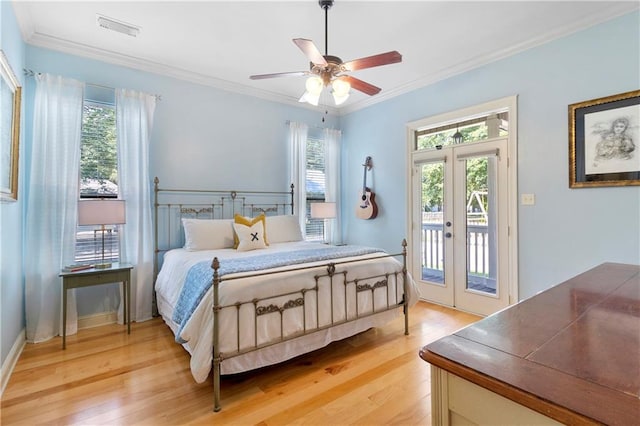 bedroom featuring crown molding, multiple windows, access to exterior, and light hardwood / wood-style flooring