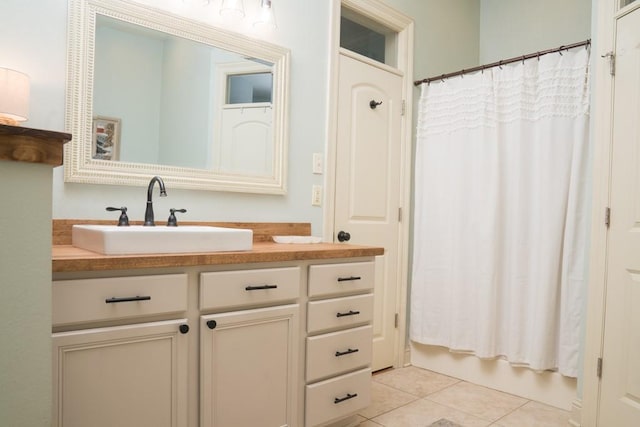 bathroom featuring vanity, tile patterned floors, and shower / tub combo with curtain