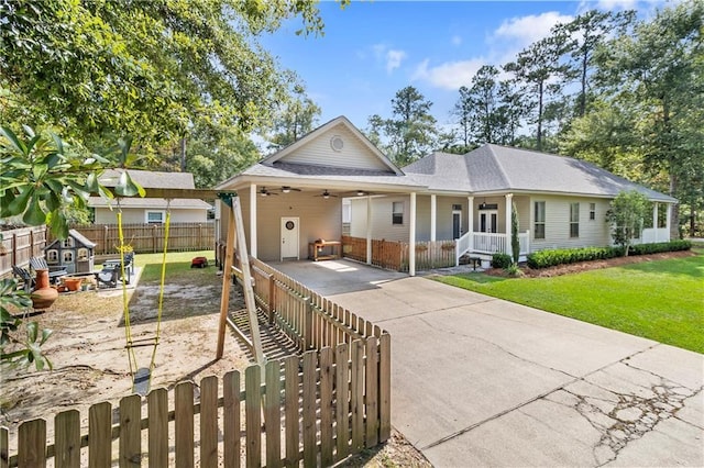 ranch-style home with a carport, a front yard, and covered porch