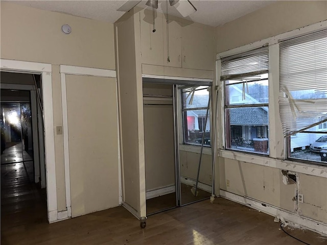 unfurnished bedroom featuring dark wood-type flooring