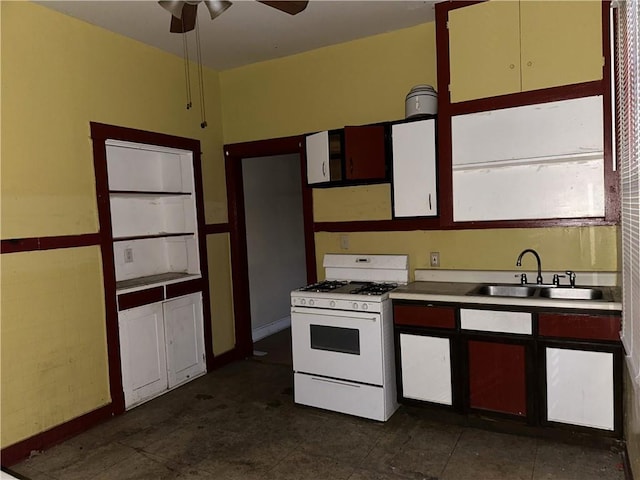 kitchen with ceiling fan, sink, and white gas stove