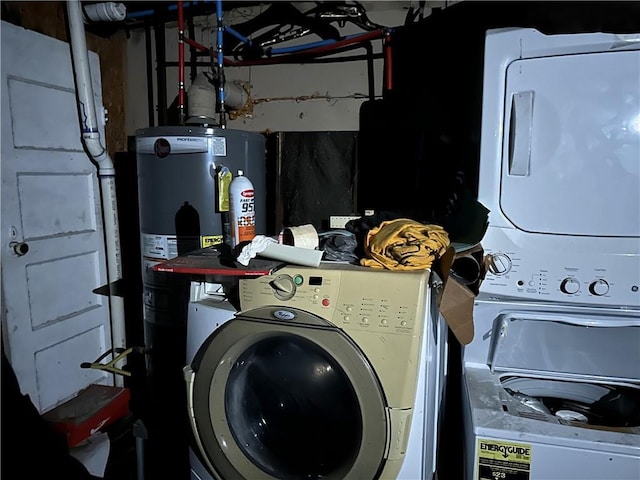 laundry room featuring water heater and stacked washer / drying machine