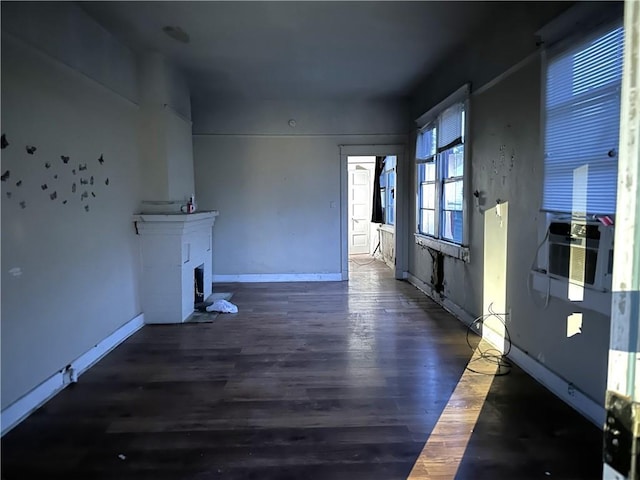 unfurnished living room with dark wood-type flooring