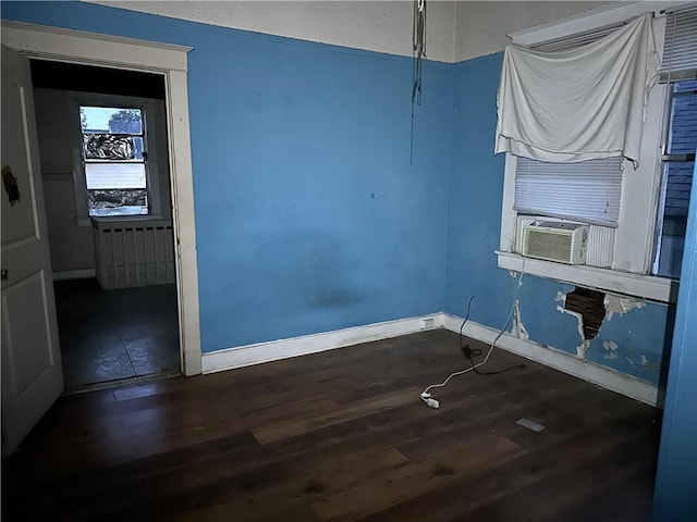 spare room featuring dark wood-type flooring and cooling unit