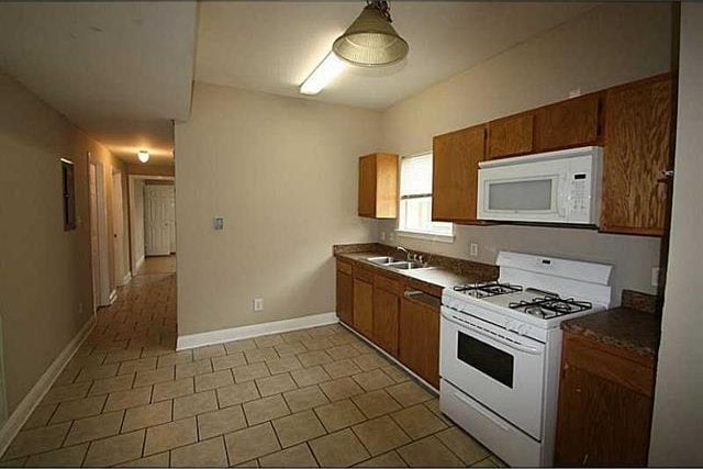 kitchen featuring sink and white appliances