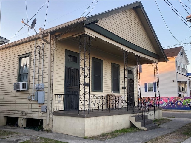 view of property exterior featuring a porch and cooling unit