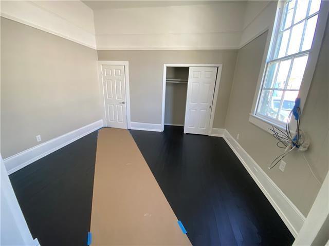 unfurnished bedroom with dark hardwood / wood-style flooring