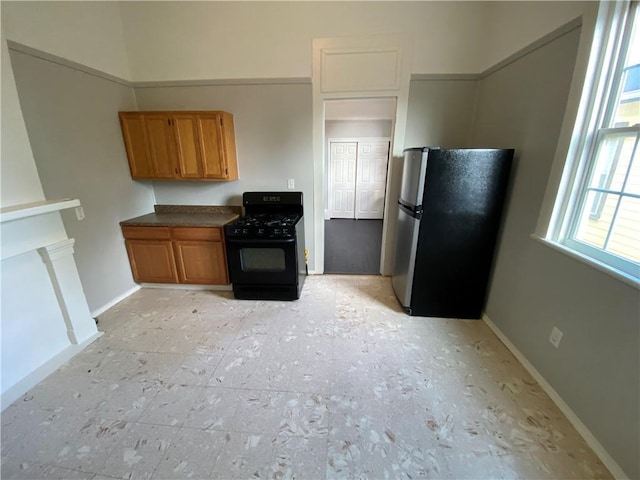 kitchen with stainless steel refrigerator and black range with gas cooktop