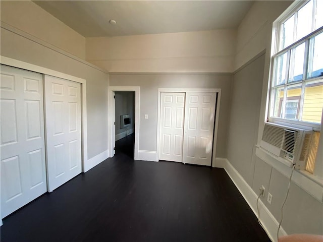 unfurnished bedroom with dark hardwood / wood-style flooring and a closet