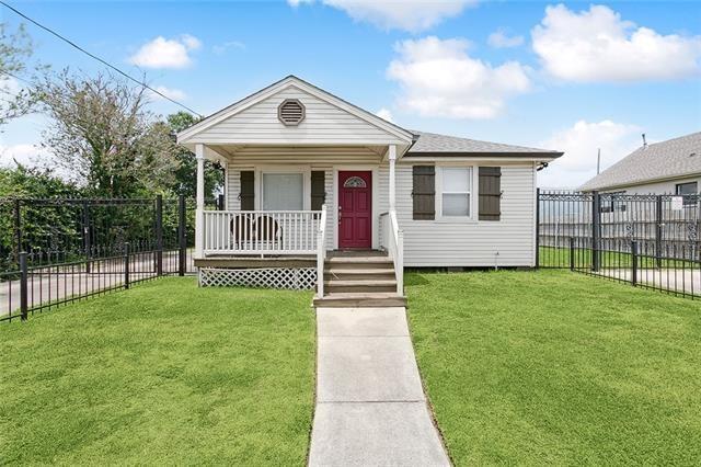 bungalow-style home with a porch and a front lawn