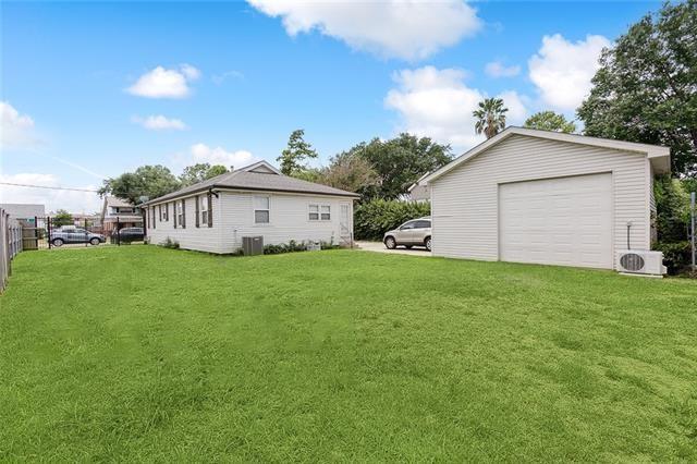 view of side of home featuring a garage and a yard