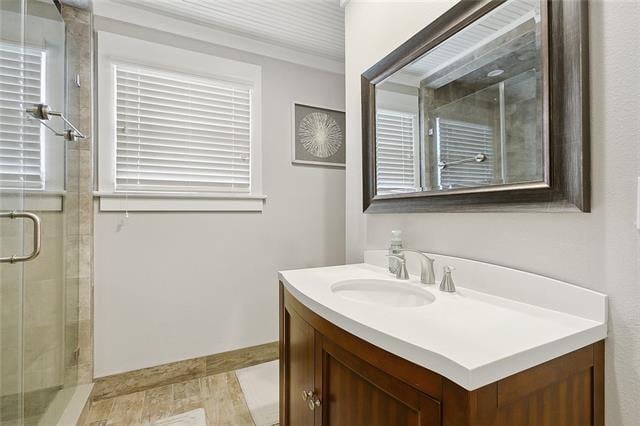 bathroom featuring vanity and an enclosed shower