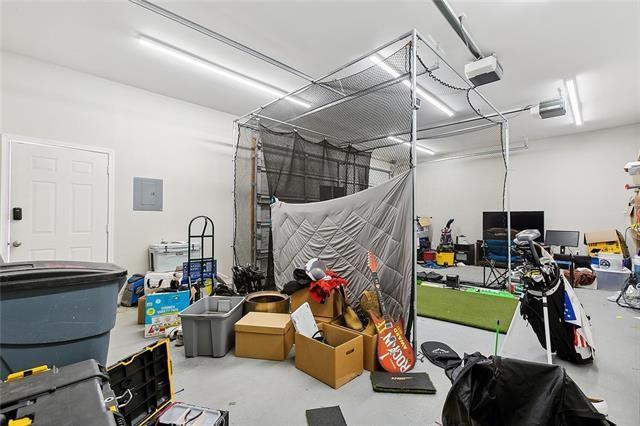 garage with a garage door opener and electric panel