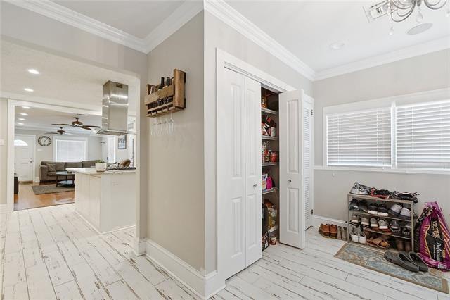 hallway featuring crown molding and light hardwood / wood-style floors