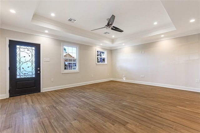 entryway featuring ceiling fan, ornamental molding, dark hardwood / wood-style floors, and a raised ceiling