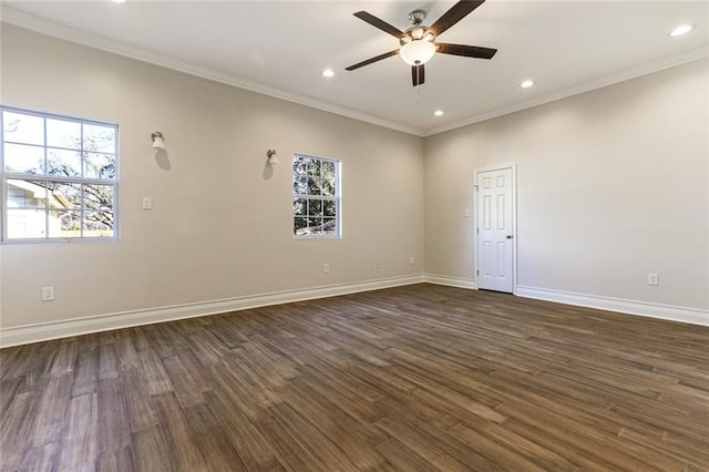 spare room with ornamental molding, dark wood-type flooring, and a wealth of natural light