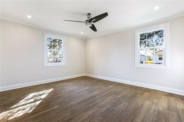 empty room with ornamental molding, ceiling fan, and dark hardwood / wood-style flooring