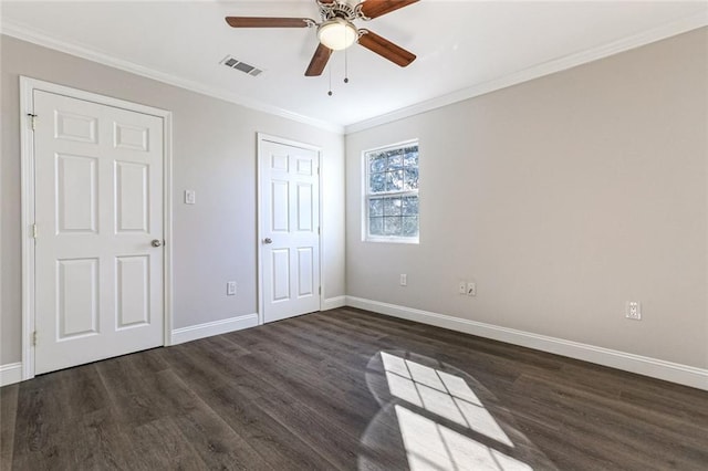 unfurnished bedroom featuring dark hardwood / wood-style flooring, crown molding, and ceiling fan