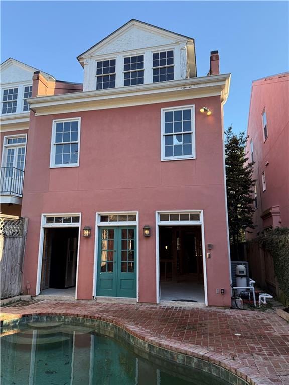 rear view of property with a patio area and french doors