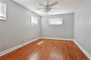 unfurnished room featuring wood-type flooring and ceiling fan