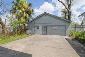 exterior space with an outbuilding, a garage, and central AC