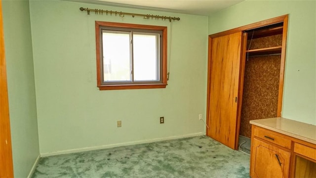 bedroom with light colored carpet and a closet