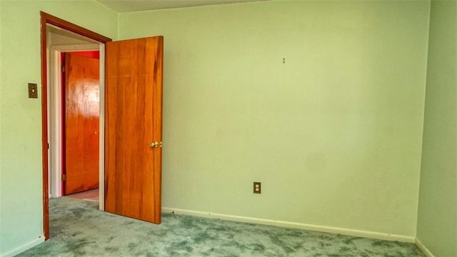 spare room featuring light colored carpet