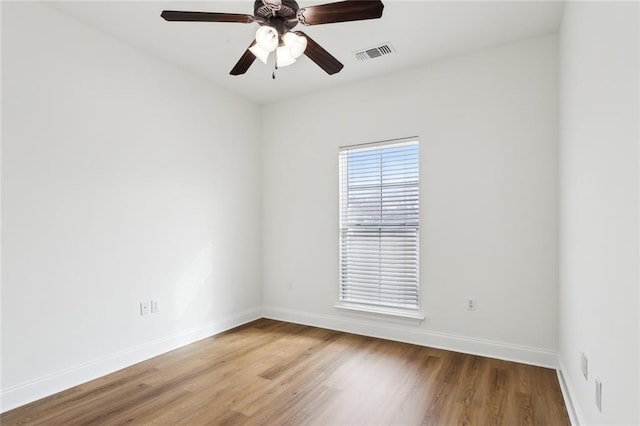 empty room featuring hardwood / wood-style flooring and ceiling fan