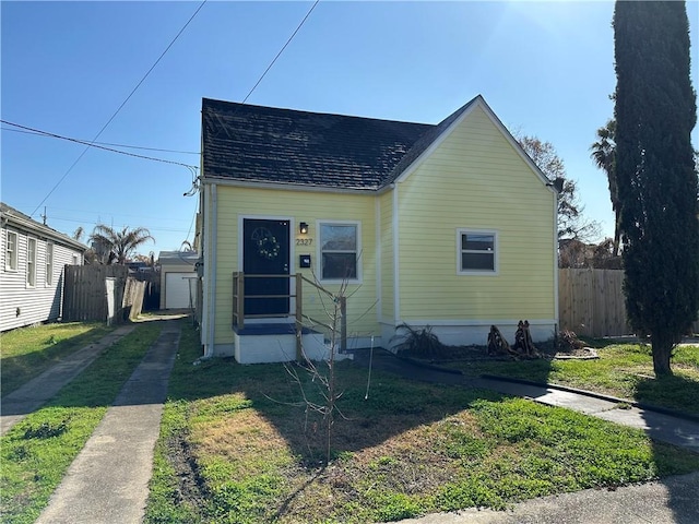 bungalow-style house with a front lawn