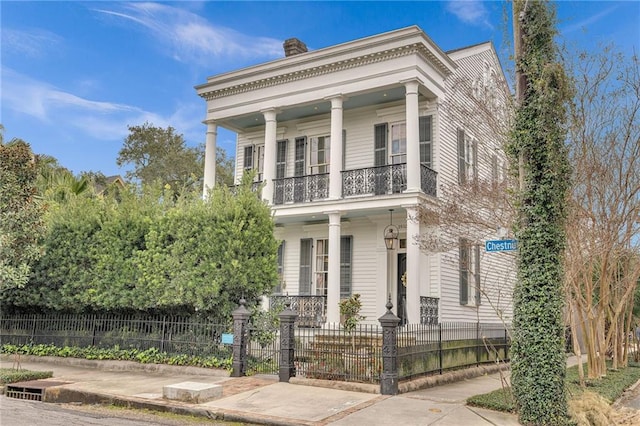 greek revival inspired property with a balcony