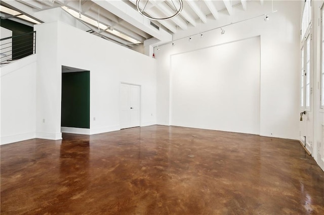 spare room featuring a towering ceiling