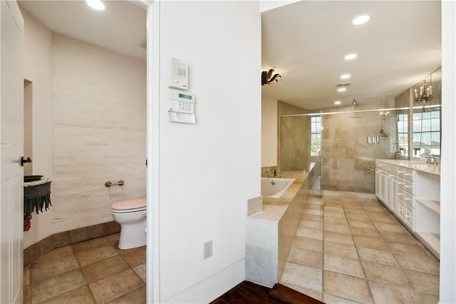 full bathroom featuring vanity, toilet, shower with separate bathtub, and a chandelier