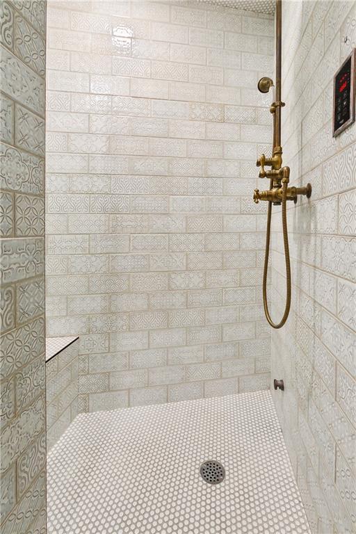 bathroom with tiled shower