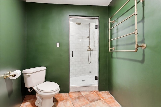 bathroom featuring an enclosed shower, tile patterned floors, and toilet