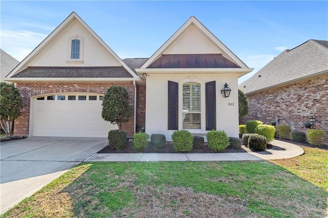 view of front of home with a garage and a front lawn