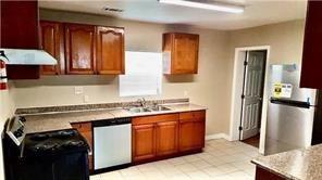 kitchen with sink, range hood, dishwasher, and range