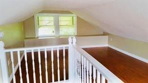 bonus room with radiator and vaulted ceiling