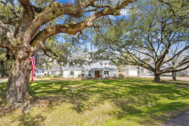 view of front of property with a garage and a front lawn