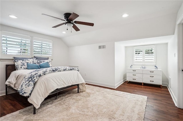 bedroom featuring multiple windows, dark wood-type flooring, lofted ceiling, and ceiling fan