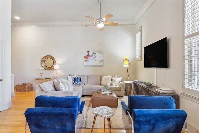 living room featuring crown molding, ceiling fan, and hardwood / wood-style flooring