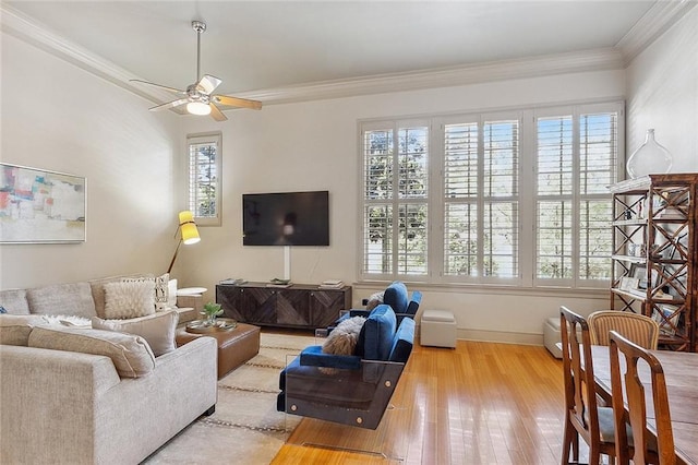 living room with crown molding, ceiling fan, and wood-type flooring