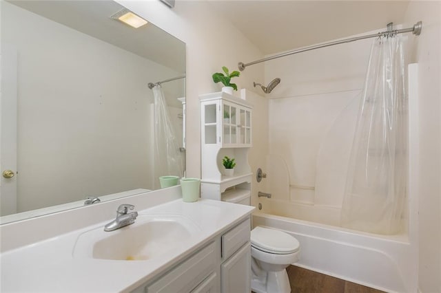 full bathroom featuring hardwood / wood-style flooring, toilet, vanity, and shower / bath combo with shower curtain