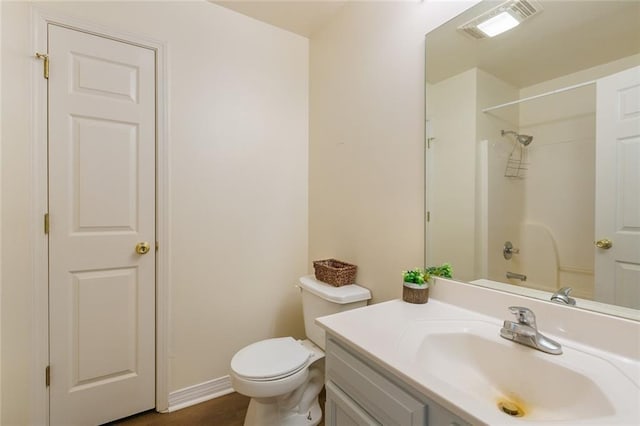 full bathroom featuring vanity,  shower combination, and toilet