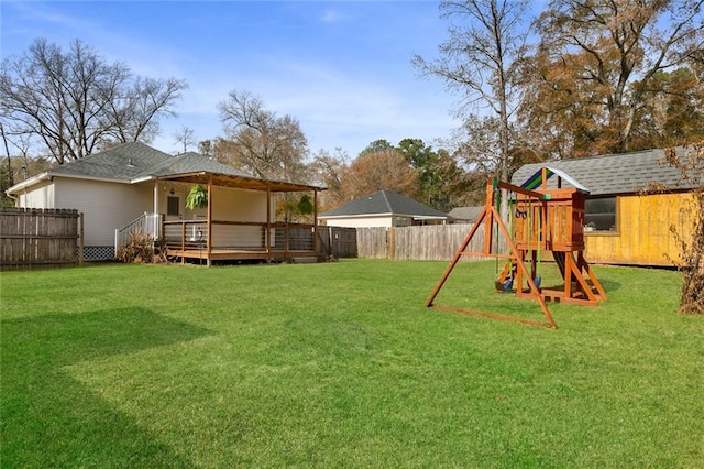 view of yard with a wooden deck and a playground